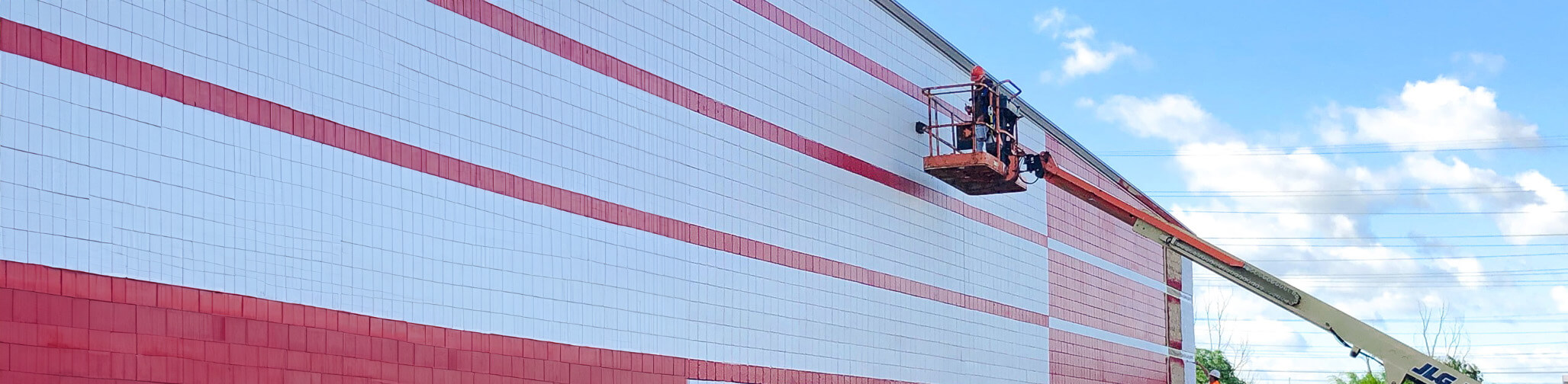 Contractor painting the outside of a commerical building