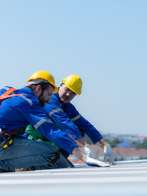 roofer completing a pvc roof inspection in Rochester, NY
